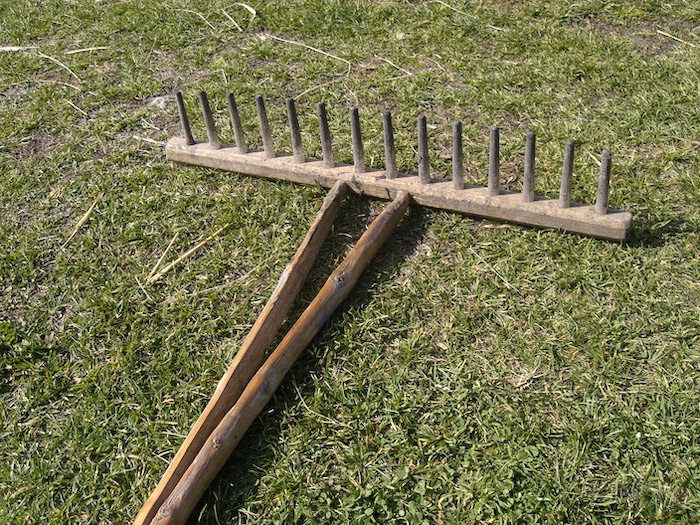 wooden rake on ground